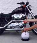A PELA oil extractor draining the oil on a motorcycle